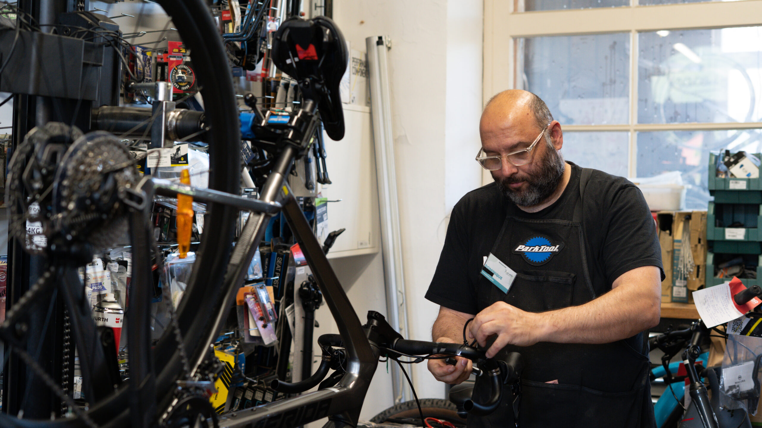 Bicycle repair tools and replacement components arranged for workshop servicing